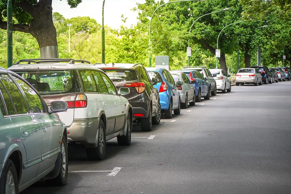 row of cars on suburban street